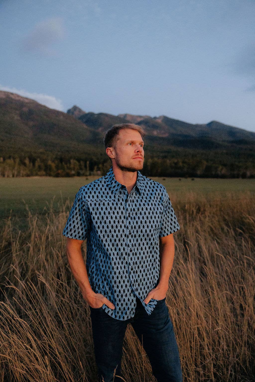 Hey Bear! men's button-down dress shirt by Made of Mountains, featuring a classic collar and stylish fabric in a close-up view.