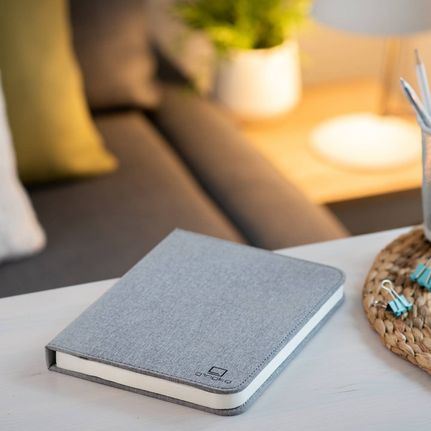Gingko Design linen fabric smart book light lamp with soft glow, designed for reading and ambient illumination.