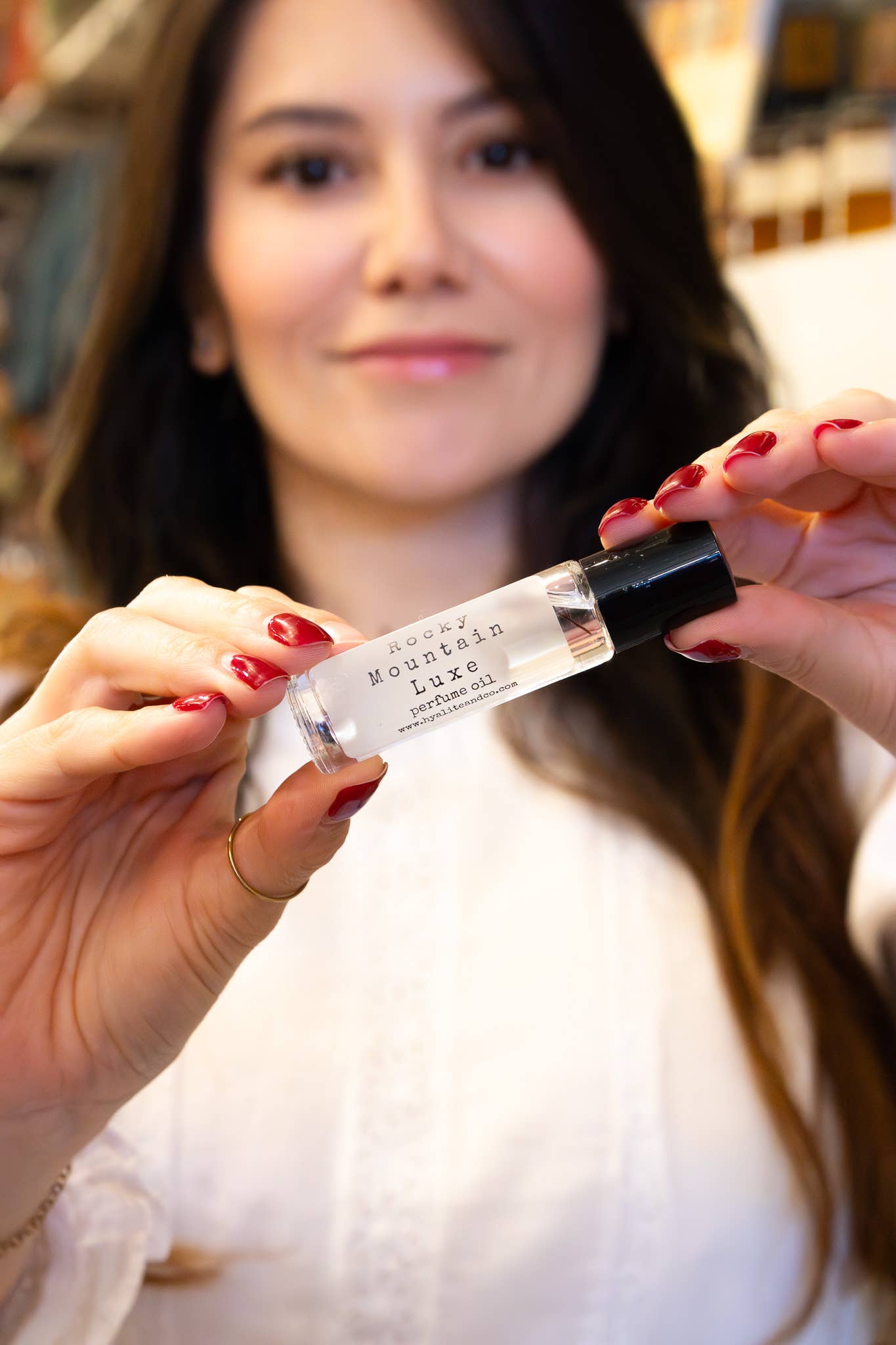 Hyalite & Co roll-on perfume oil with a sleek glass bottle and metal rollerball for easy application and elegant scent.