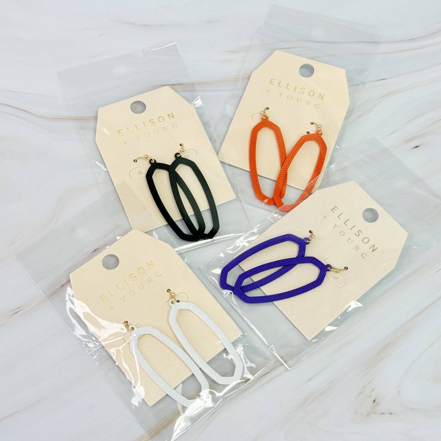 Ellison+Young Shape Of Game earrings featuring modern geometric design in silver-tone metal on a white background.