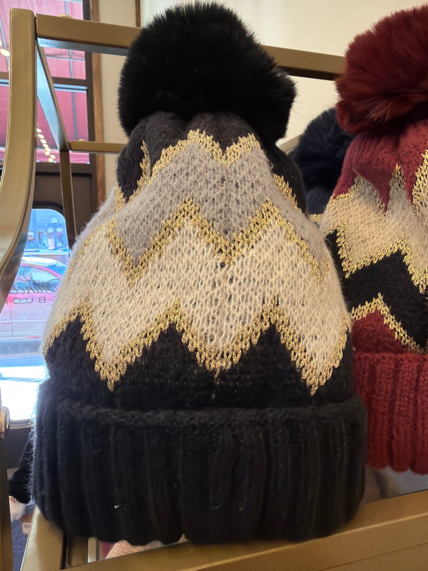Joia pom pom hat with colorful knit design, cozy winter hat featuring a fluffy pom pom on top.