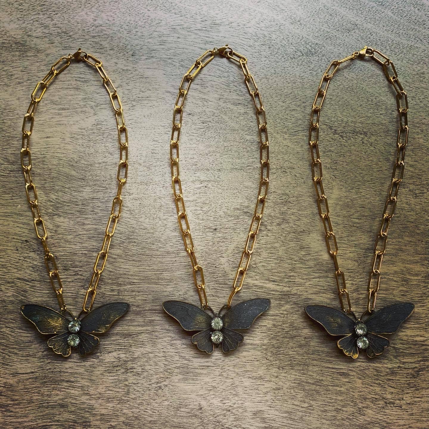 Chasing Cherubs Flutter necklace featuring a delicate gold chain with a small, elegant pendant design.