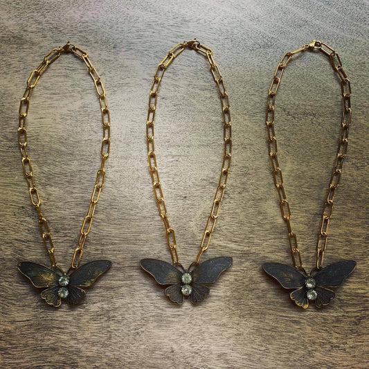 Chasing Cherubs Flutter necklace featuring a delicate gold chain with a small, elegant pendant design.