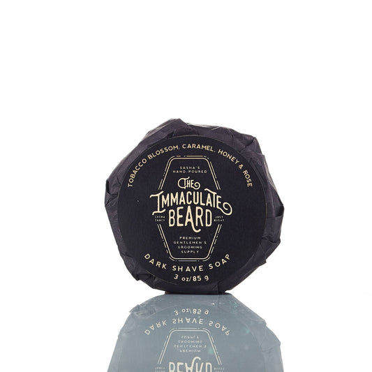 The Immaculate Beard shave soap puck with a smooth, round surface in a natural color, designed for a rich, creamy lather.