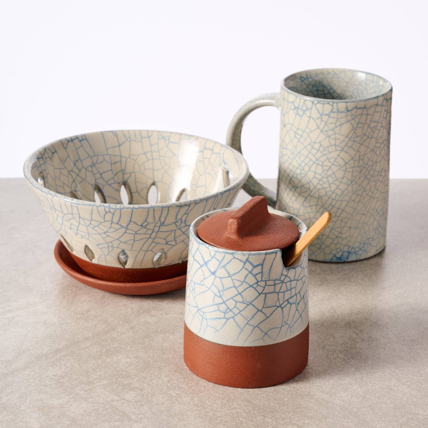 Ten Thousand Villages Ciya Blue Crackle Honey Pot with lid, ceramic container featuring a vibrant blue crackle glaze design.