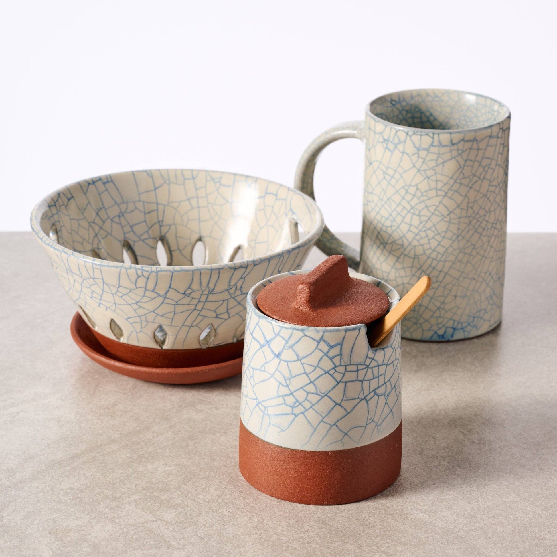 Ten Thousand Villages Ciya Blue Crackle Honey Pot with lid, ceramic container featuring a vibrant blue crackle glaze design.