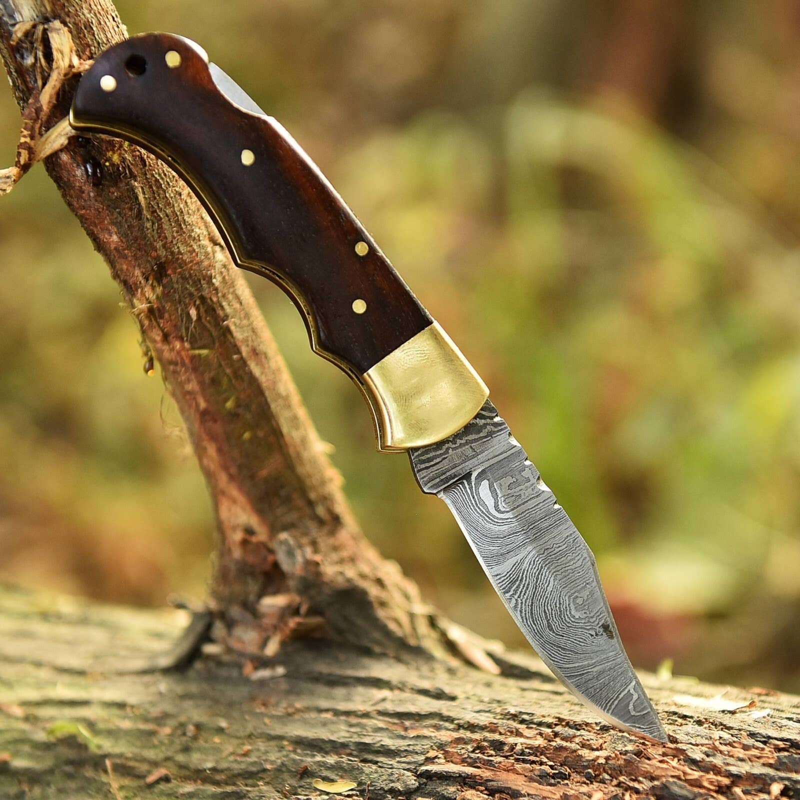 Handmade Damascus folding knife with intricate blade pattern and wooden handle, crafted by Liconte LLC.
