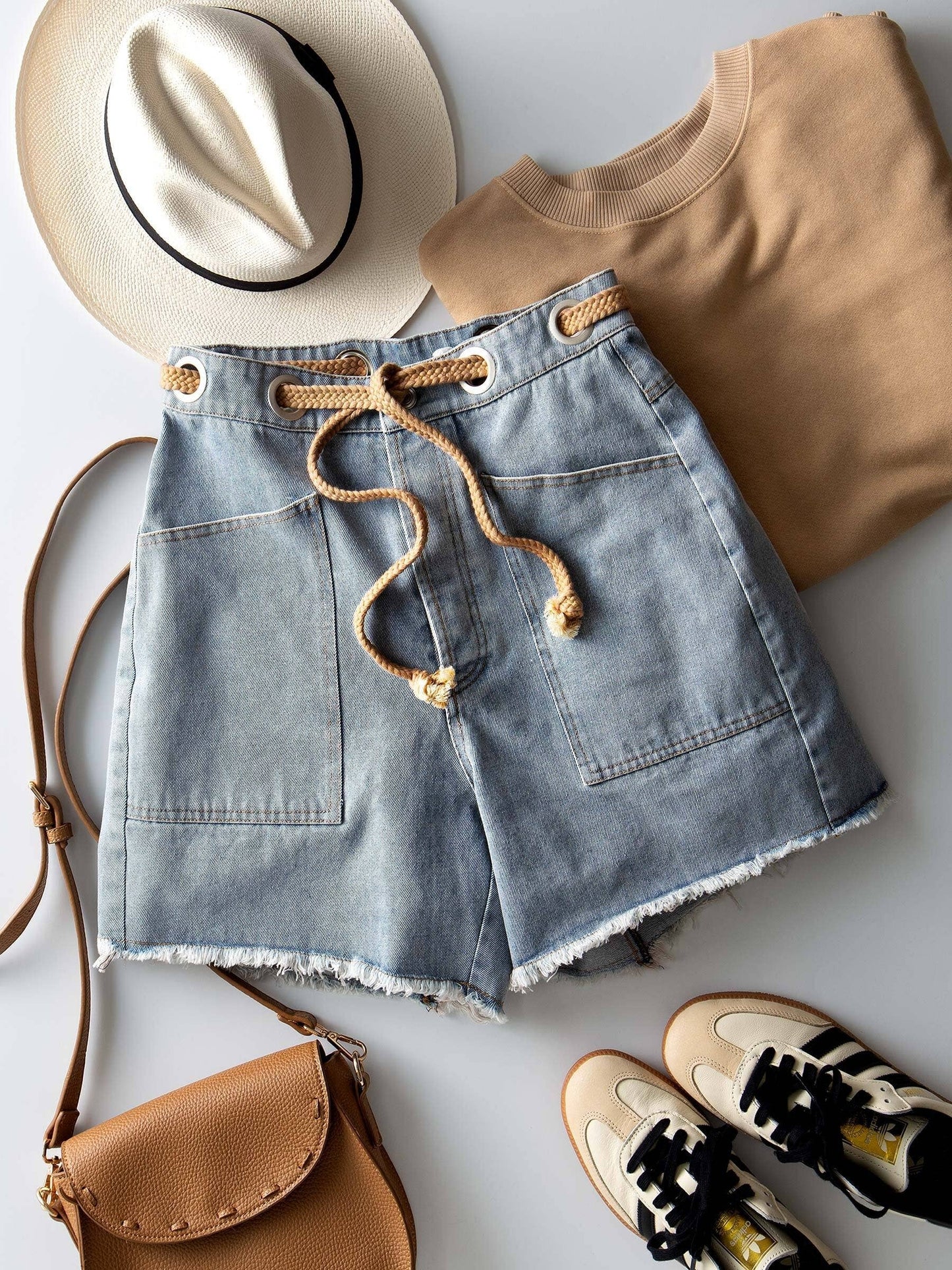 Urban Daizy high-waisted denim shorts with frayed hem, showcasing a stylish casual summer look.