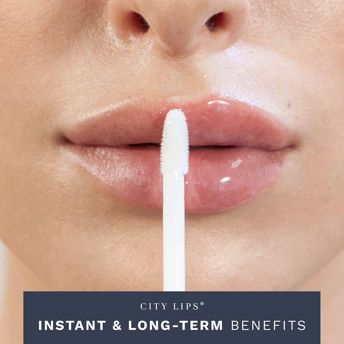 City Lips® Clear plumping lip gloss in a sleek tube, showcasing a glossy finish and smooth application on a model's lips.