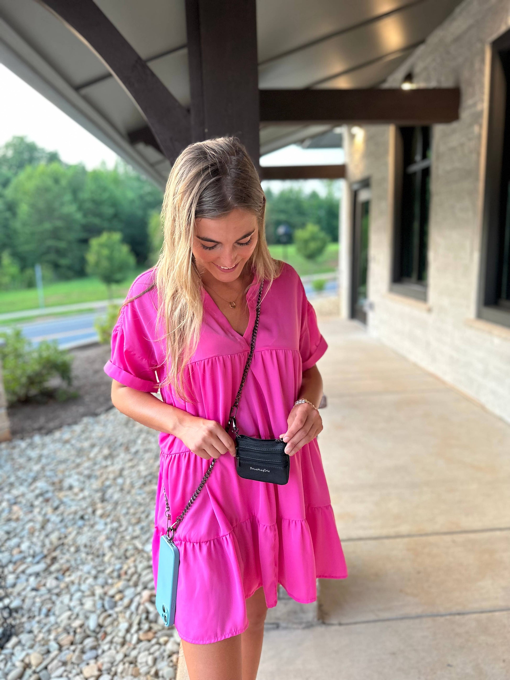 Save The Girls Clip & Go Crossbody Phone Accessory with chain strap attached to a smartphone for hands-free convenience.