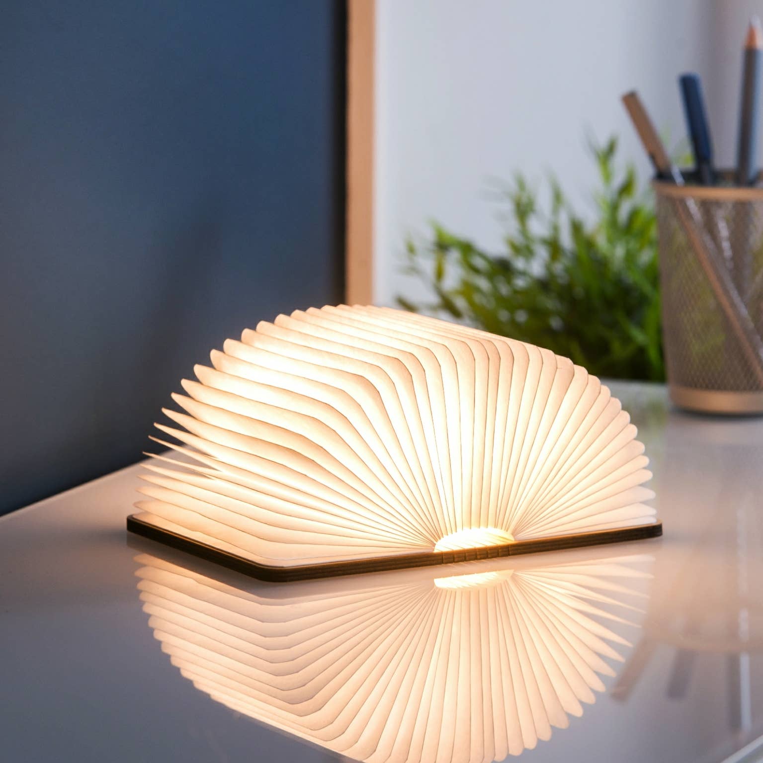 Natural wood smart book light by Gingko Design, sleek lamp with adjustable arm and integrated LED for reading or workspace illumination.
