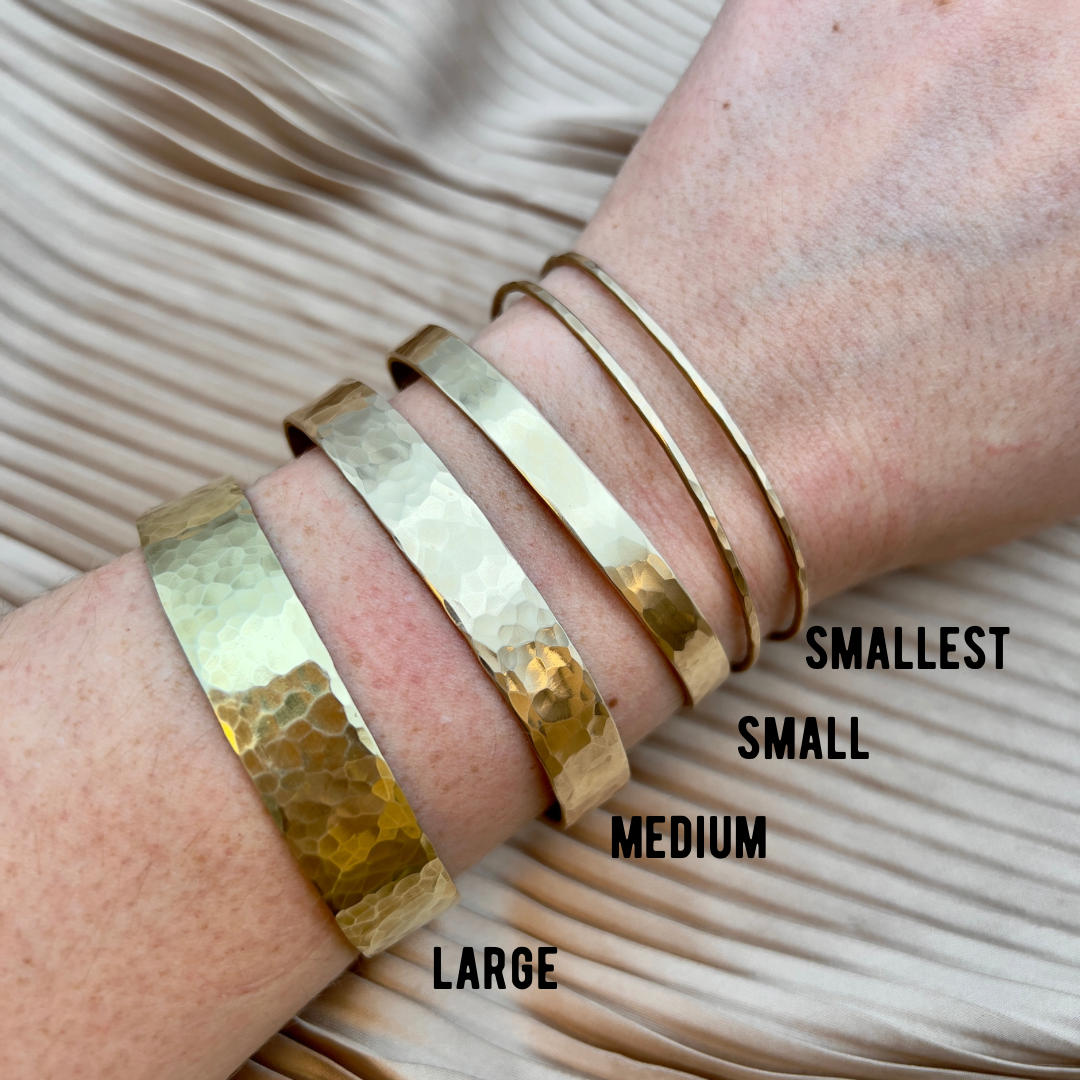Handmade She-ra cuff bracelet by Fluff Hardware featuring bold, sculpted metallic design on a wrist accessory.