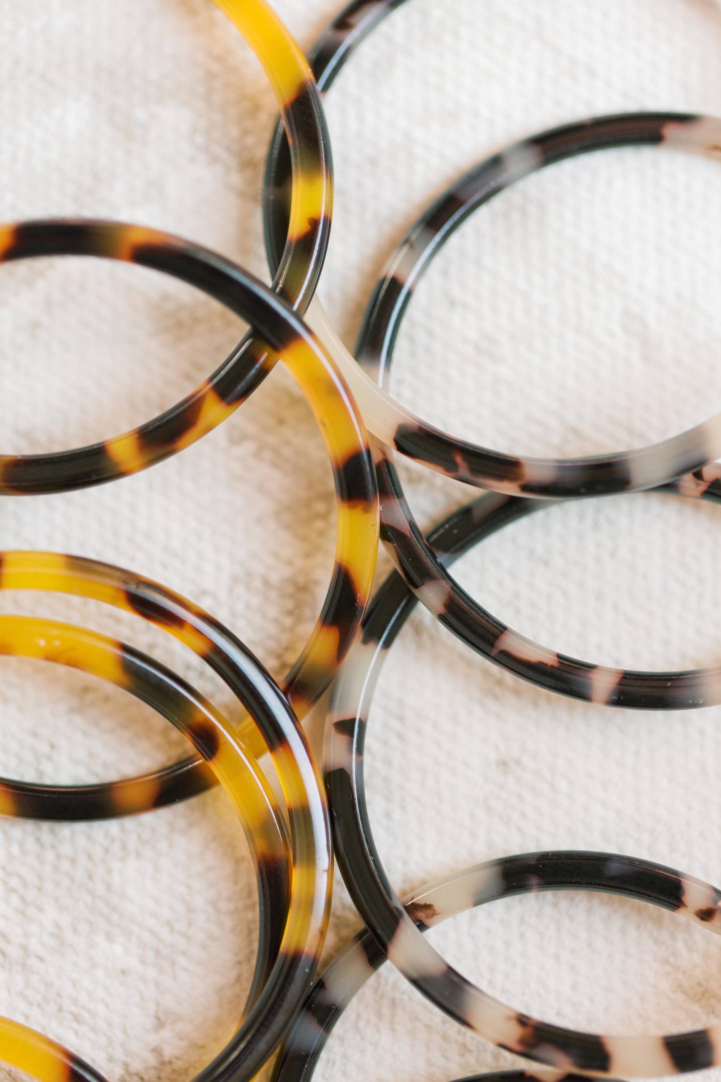 Skinny blonde tortoise hoop earrings from St Armands Designs of Sarasota, showcasing lightweight, stylish earrings with a tortoise pattern.