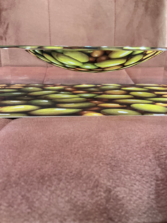A clear acrylic olive tray by The Color Connect, rectangular dish with raised edges for serving olives and snacks.
