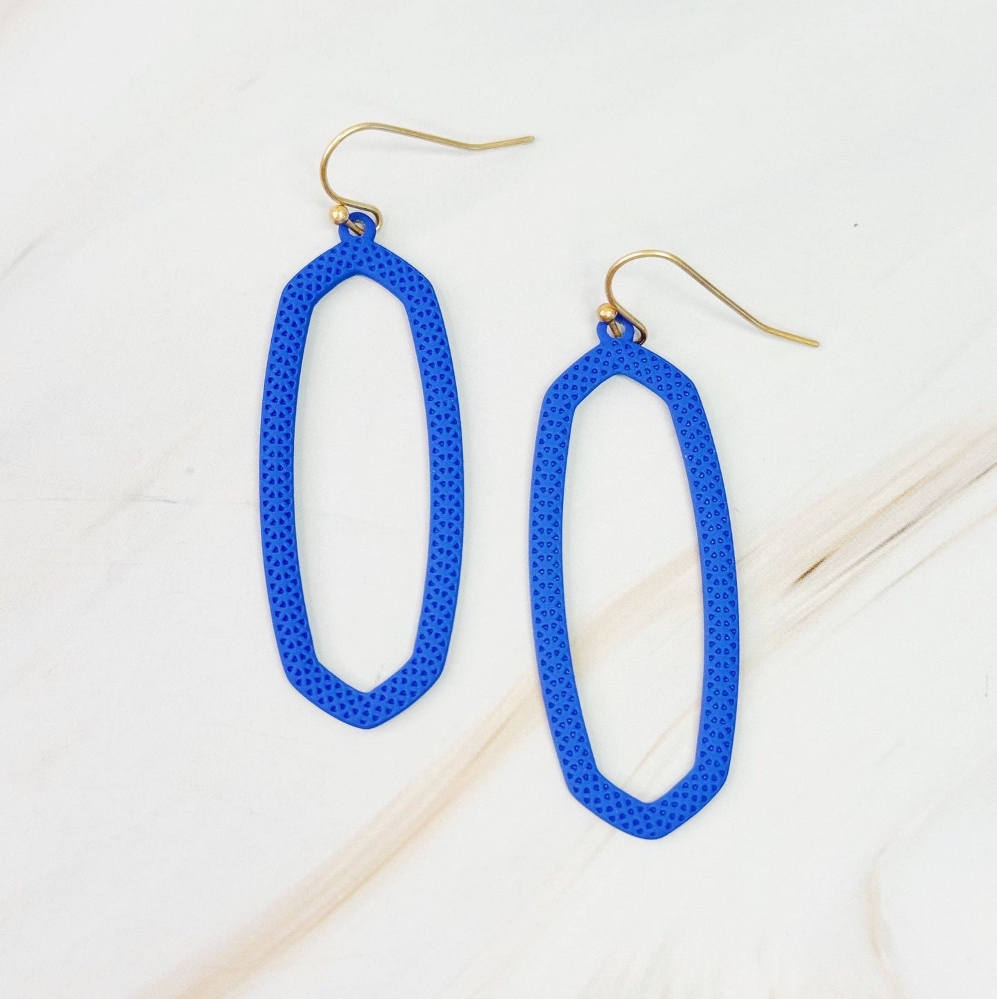 Ellison+Young Shape Of Game earrings featuring geometric design in silver tone, displayed on a neutral background.