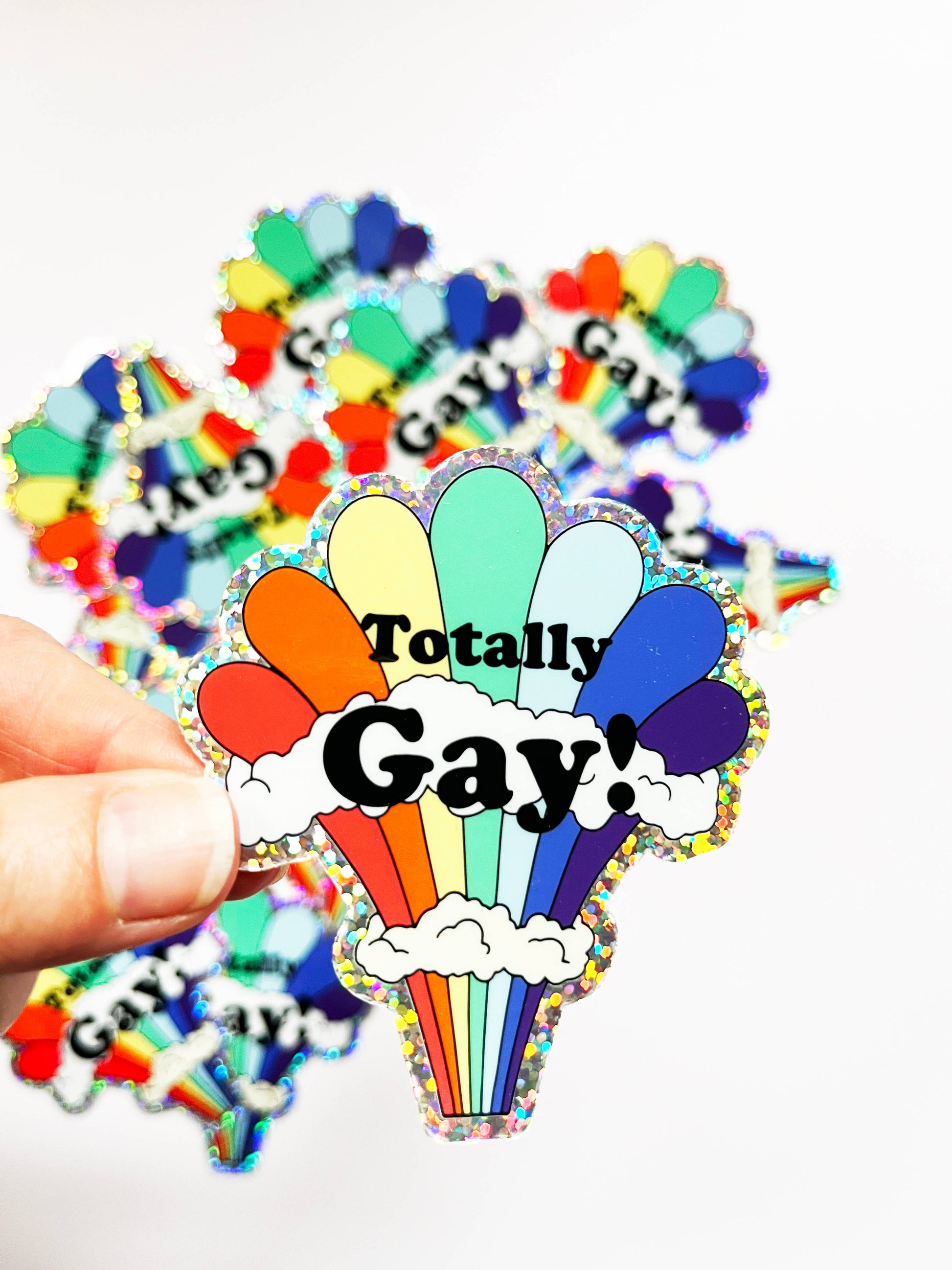 Colorful rainbow glitter sticker from The Coin Laundry featuring fun gay pride-themed design and vibrant rainbow accents.