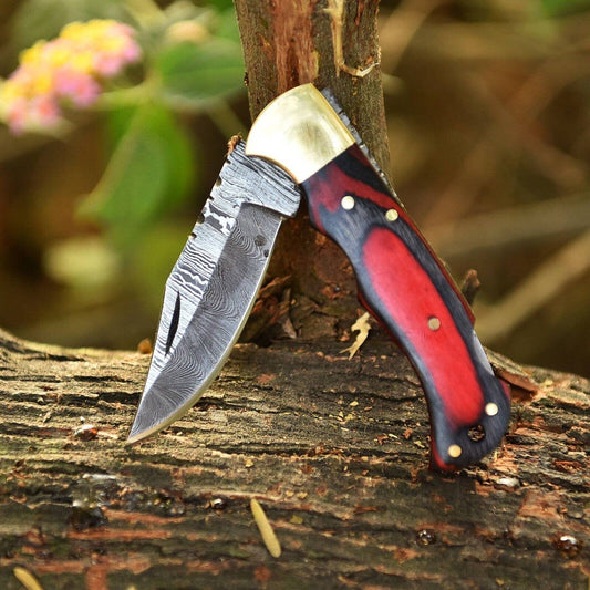 Handmade Damascus red and black wood folding knife from Liconte LLC, showing the detailed wooden handle and blade in a folded position.