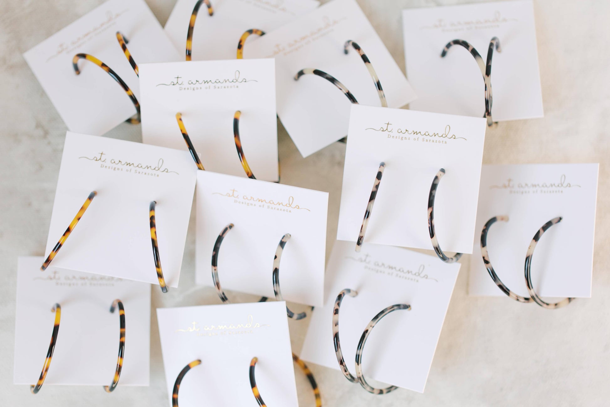 Skinny blonde tortoise hoop earrings by St Armands Designs of Sarasota, featuring slim, stylish tortoise shell hoops.