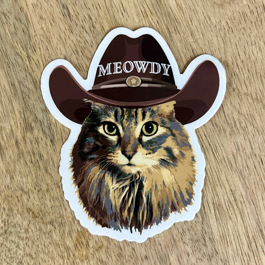 Western cat sticker by Made of Mountains featuring a playful cat design on a colorful sticker sheet.