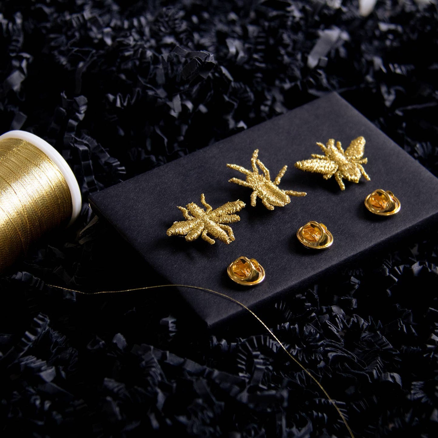 Golden embroidered brooch pins featuring three little bug designs, perfect for plant lovers and botanical decor.