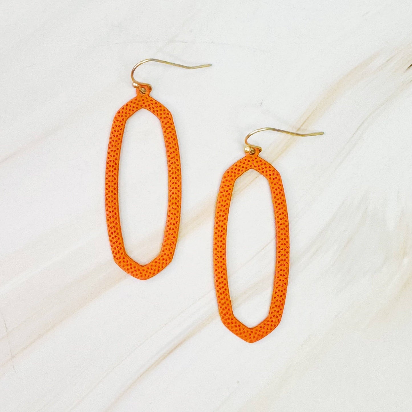 Ellison+Young Shape Of Game earrings featuring modern geometric design in silver with intricate cutouts and polished finish.