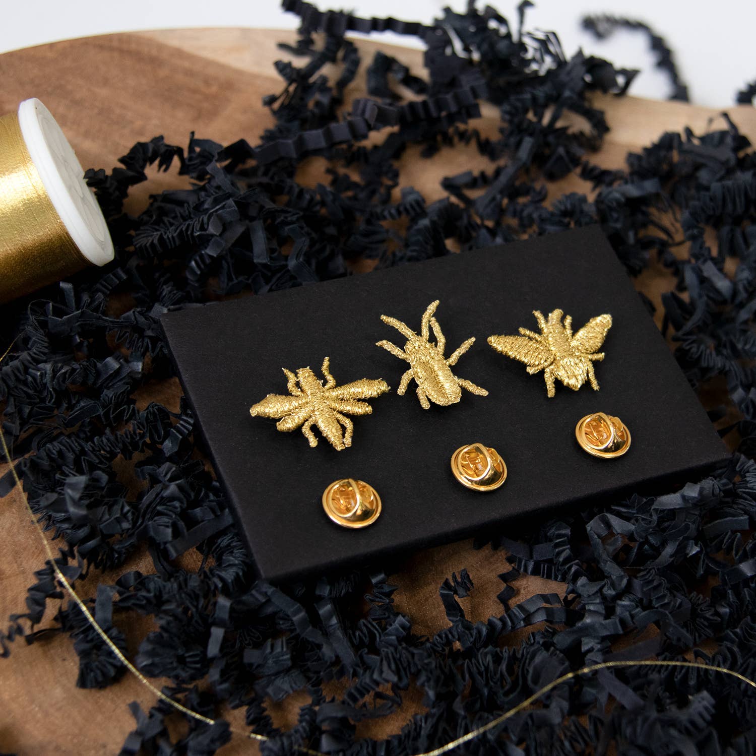 Golden embroidered brooch pins featuring three tiny bug designs, perfect for plant lovers and botanical-themed accessories.