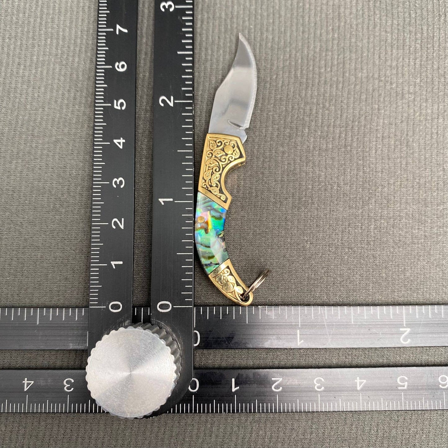 Mio Queena Shell Inlaid Tiny Knife with intricate shell inlay and compact blade, designed for detailed cutting tasks.
