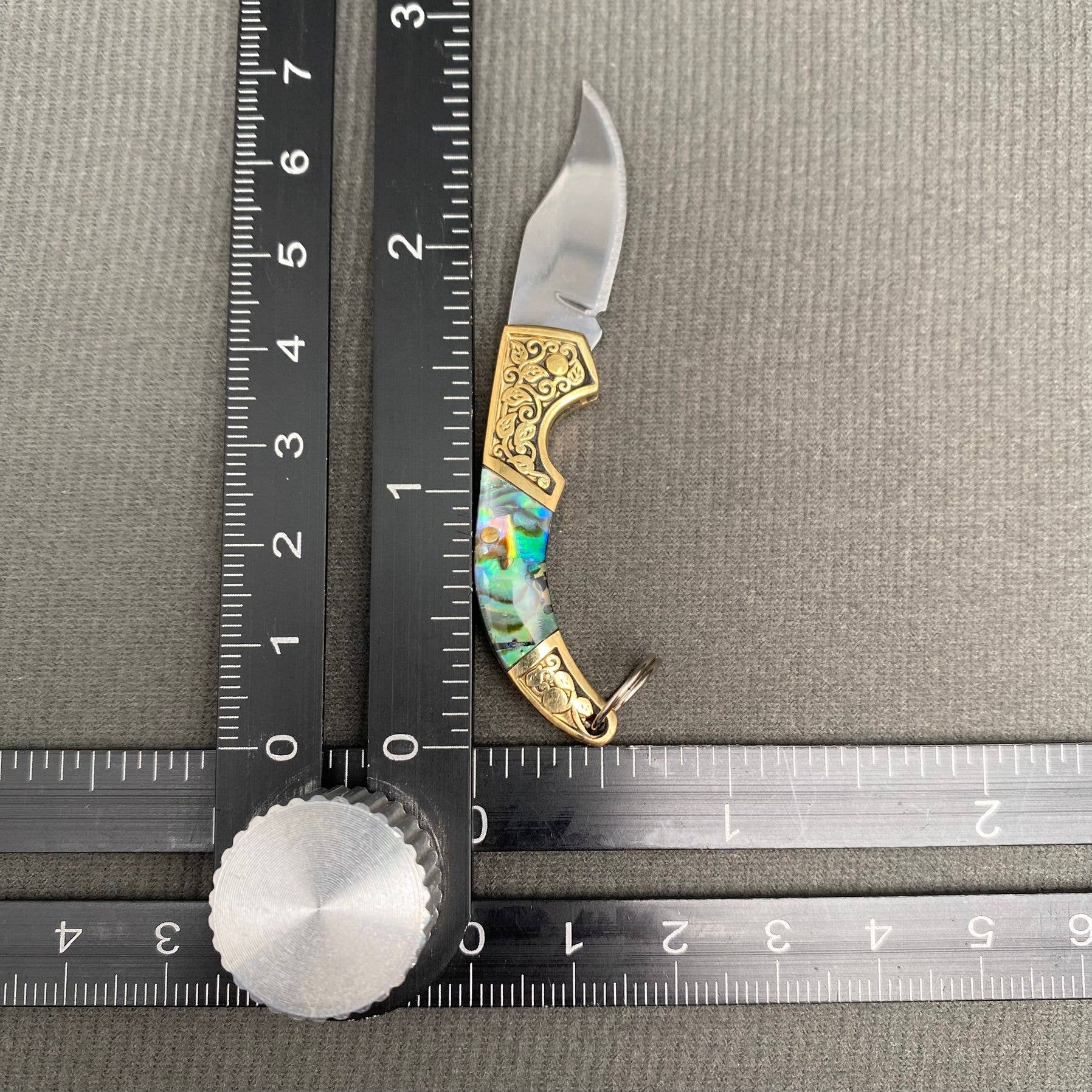 Mio Queena Shell Inlaid Tiny Knife with intricate shell inlay and compact blade, designed for detailed cutting tasks.