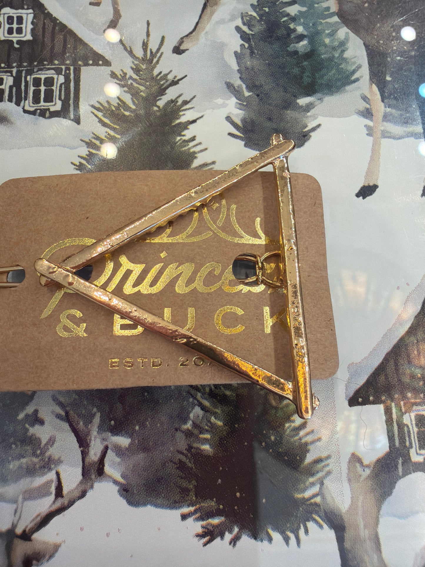 A Sparkling Mess triangle hair clip barrette with a sleek geometric design, perfect for securing hair stylishly.
