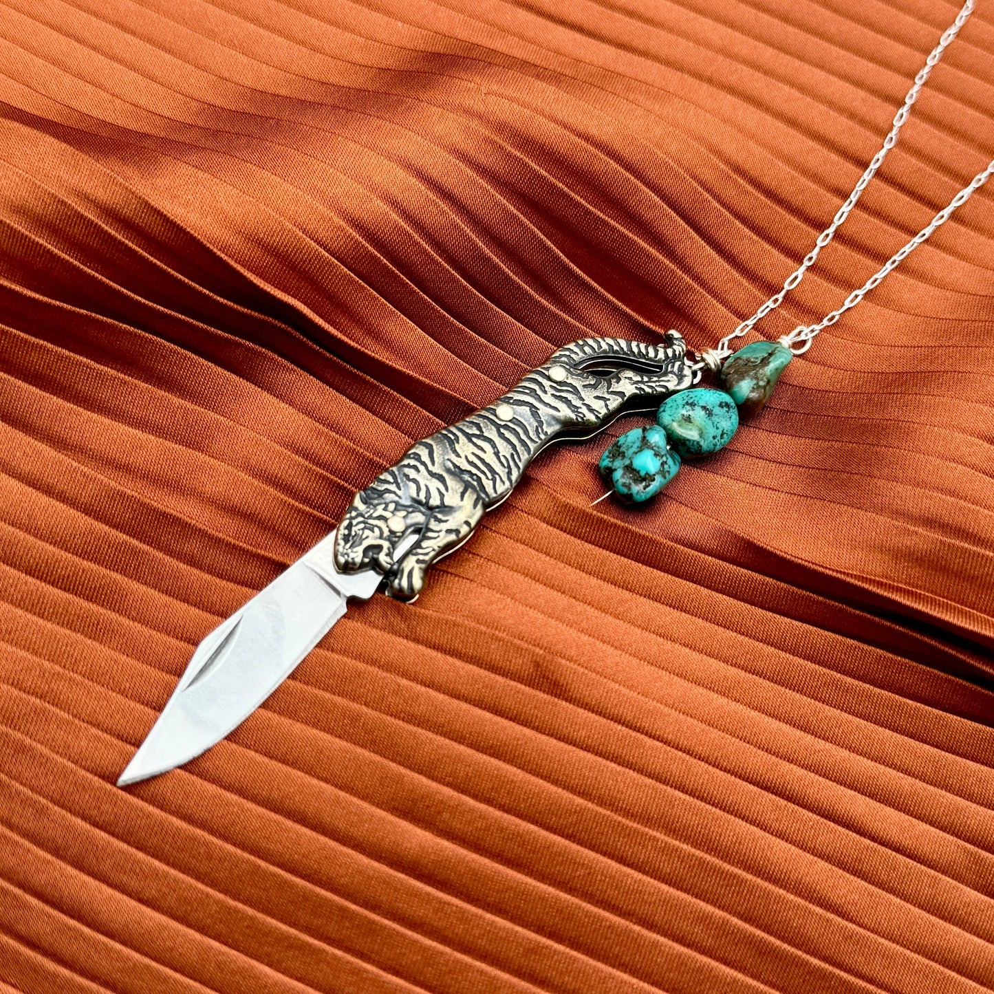 Untamed Necklace by Fluff Hardware featuring a sleek, modern pendant on a delicate chain, displayed against a neutral background.