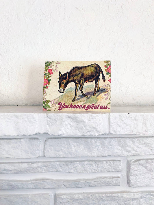 A colorful card from The Coin Laundry with playful text saying "You Have a Great Ass" for friendship encouragement and love.