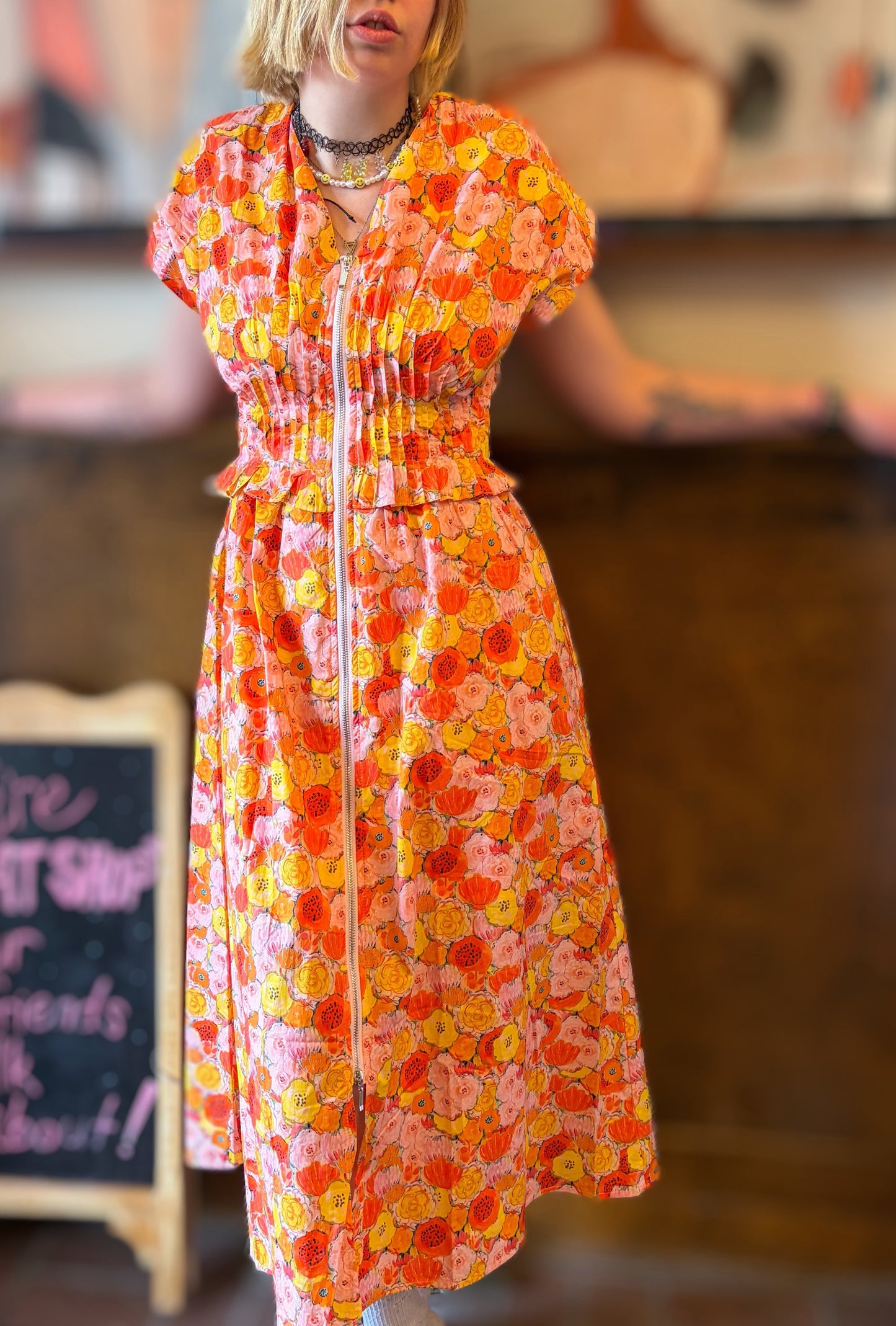 Entro Poppies Dress displayed flat with floral pattern, showcasing vibrant colors and elegant design.