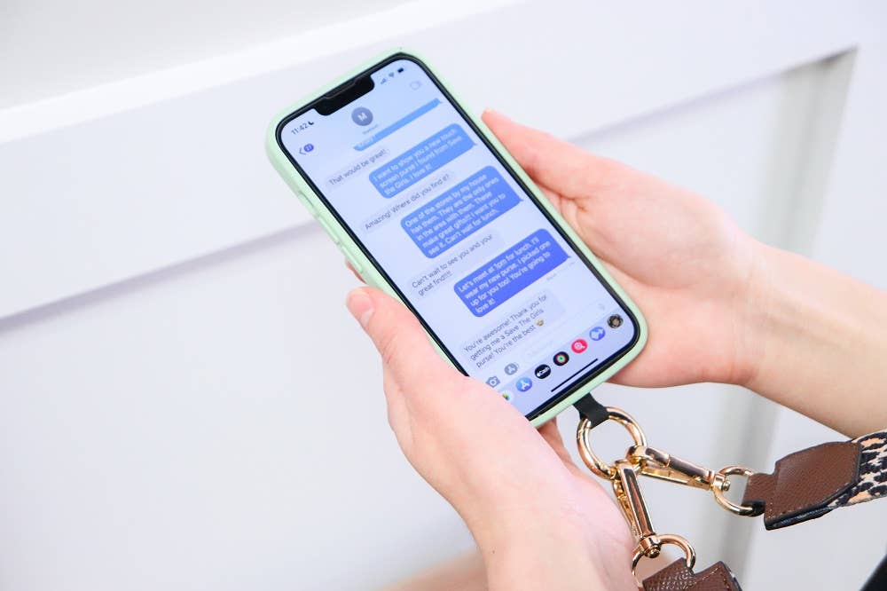 Save The Girls Clip & Go Crossbody Phone Accessory with chain strap, designed for hands-free carrying and style.