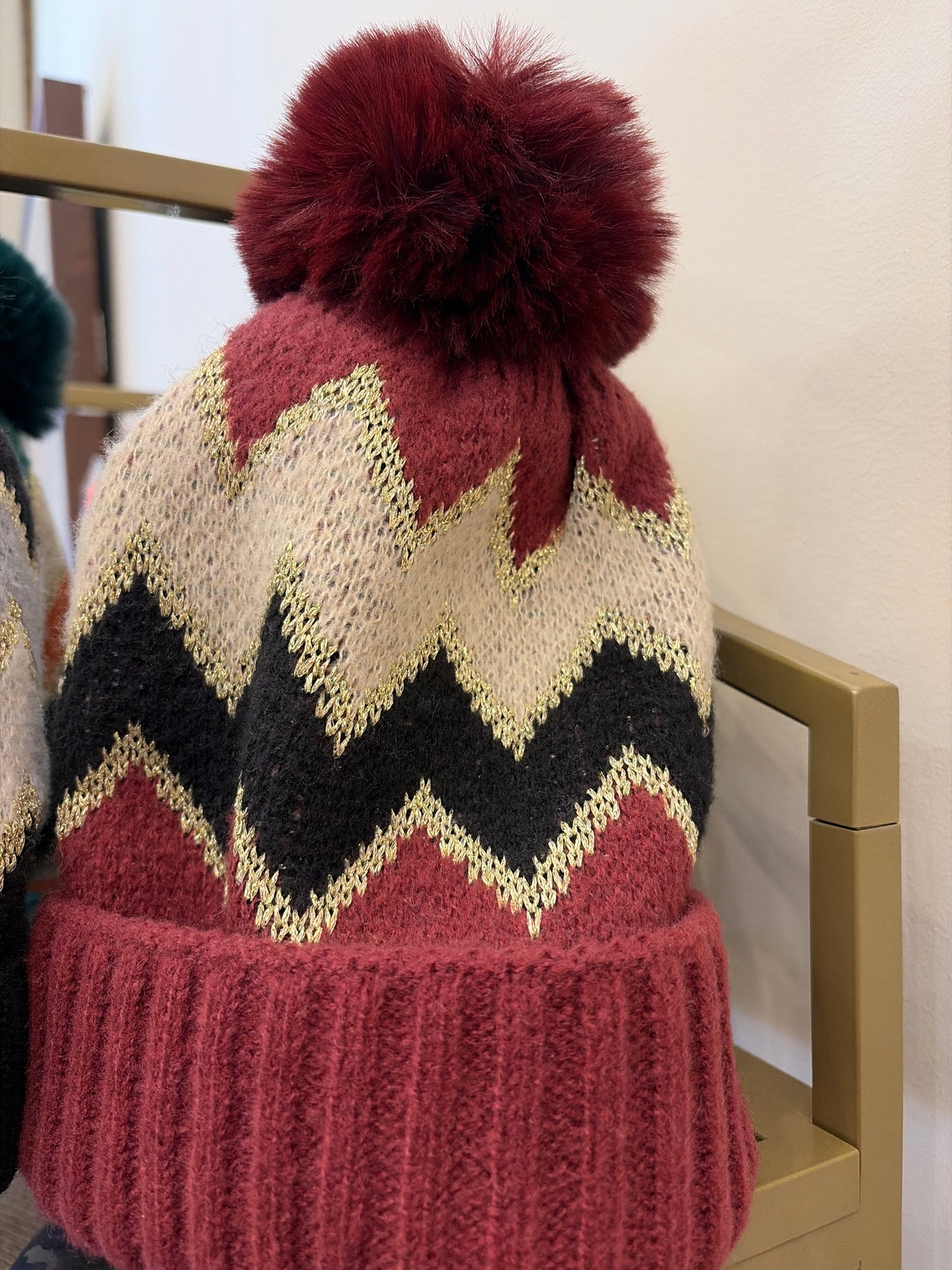 Joia pom pom hat featuring soft knit fabric and colorful pom pom on top, perfect for cozy winter style.