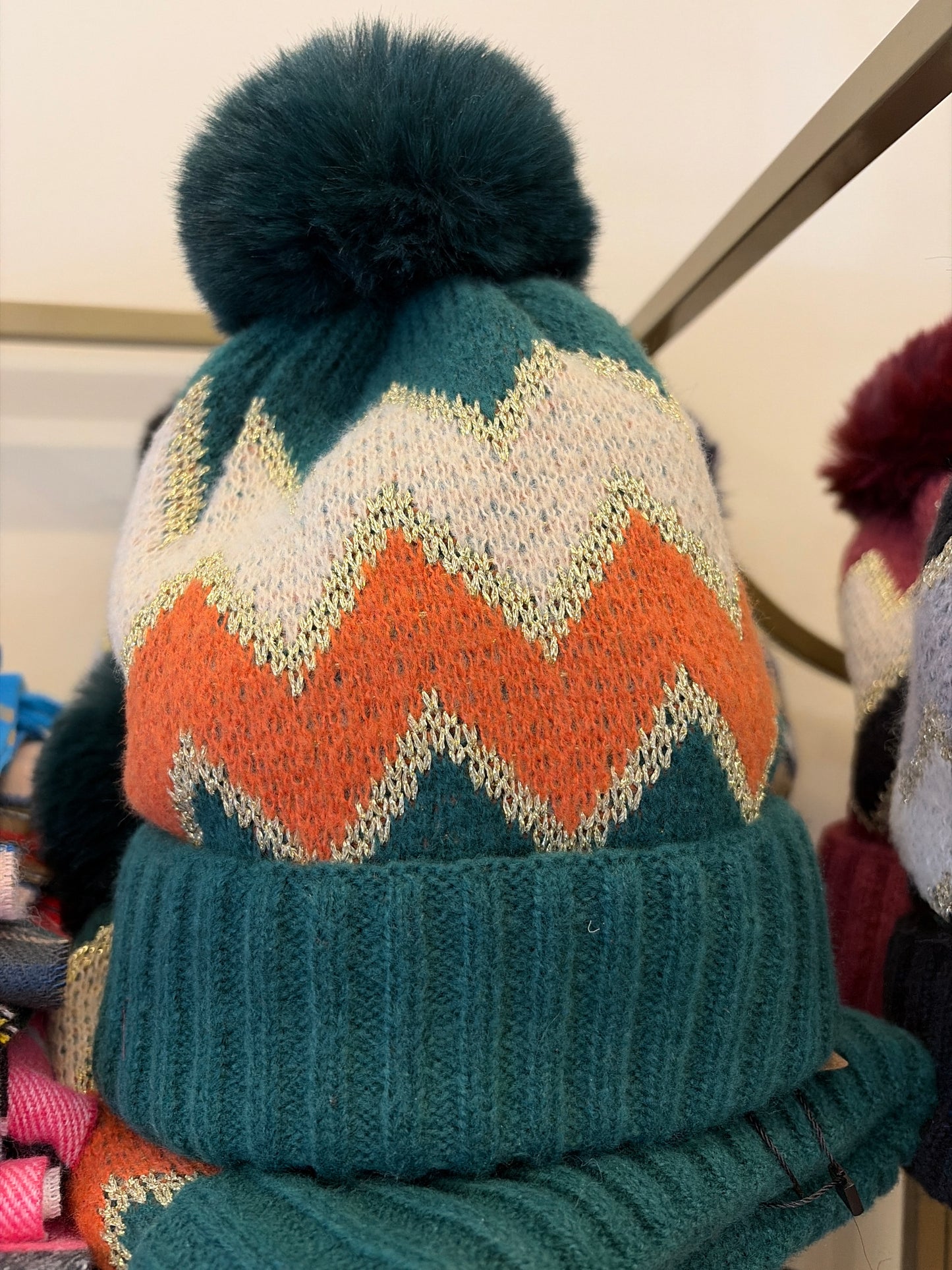 Joia pom pom hat with colorful knit pattern and fluffy pom pom on top, perfect for cold weather and winter style.