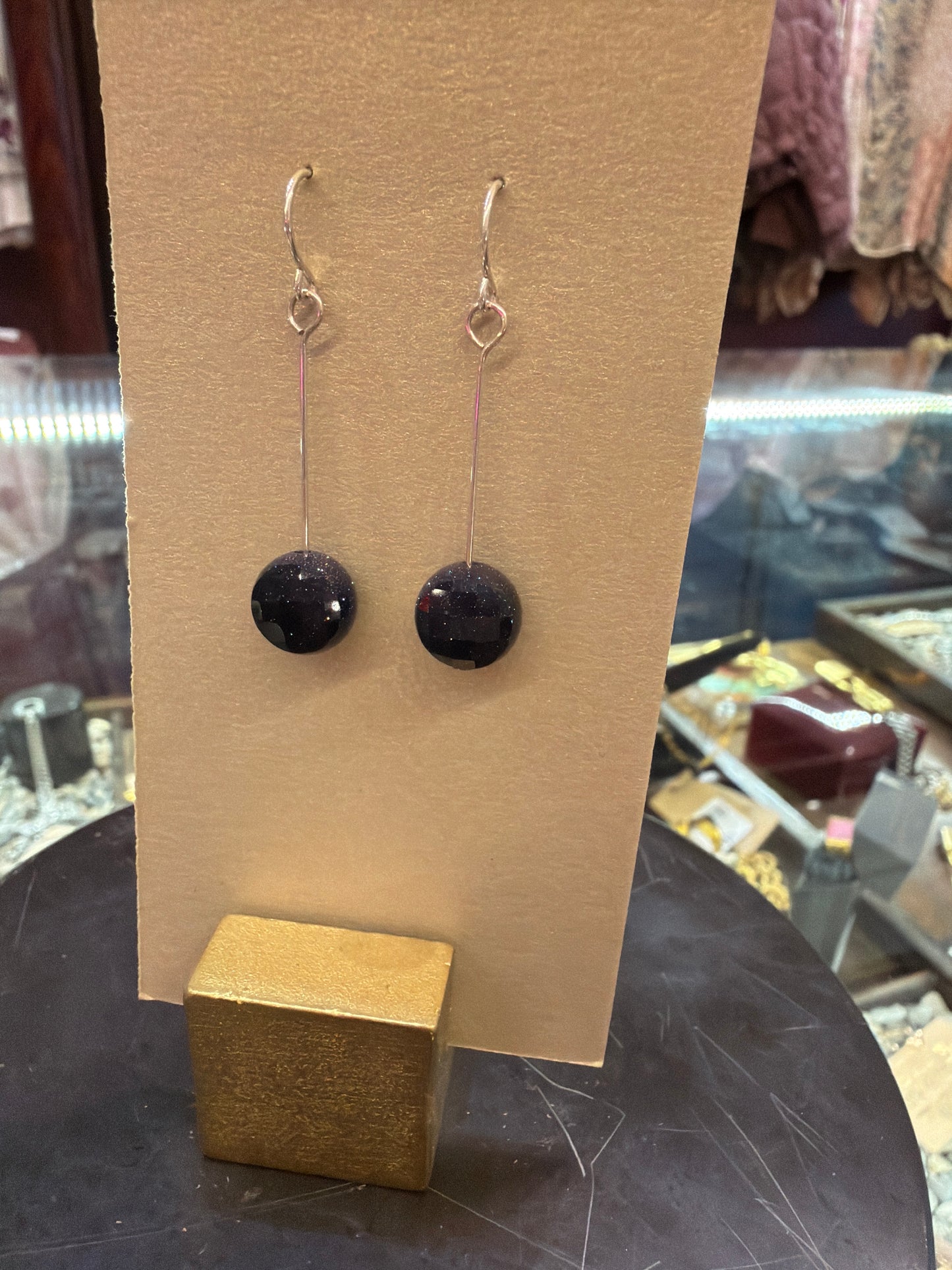 Goldust Jewelry GD semi-precious stone earrings featuring colorful gemstone drops and gold-tone hooks.