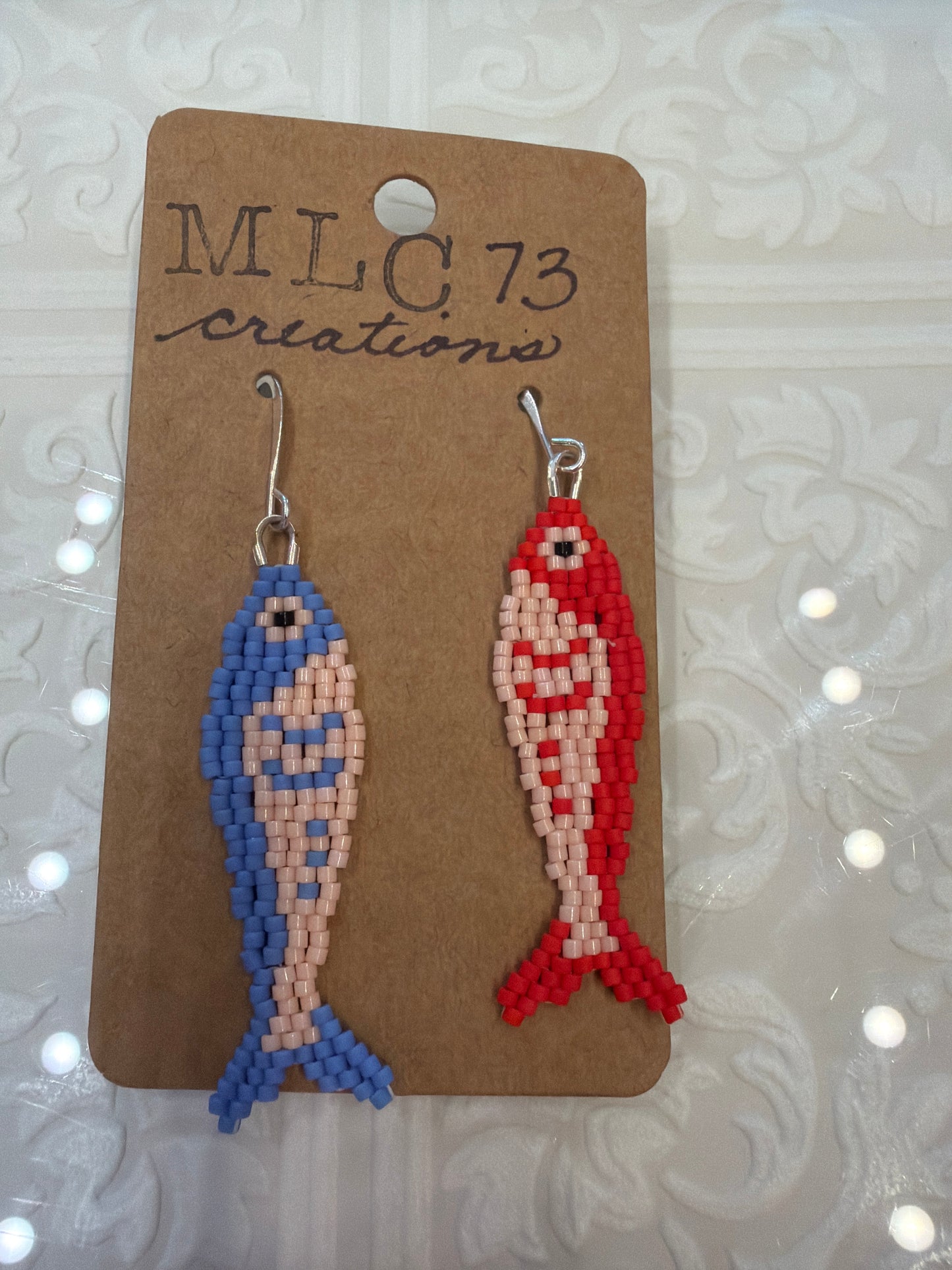 Colorful handbeaded fish earrings by MLC73 featuring vibrant beadwork and dangling fish design.