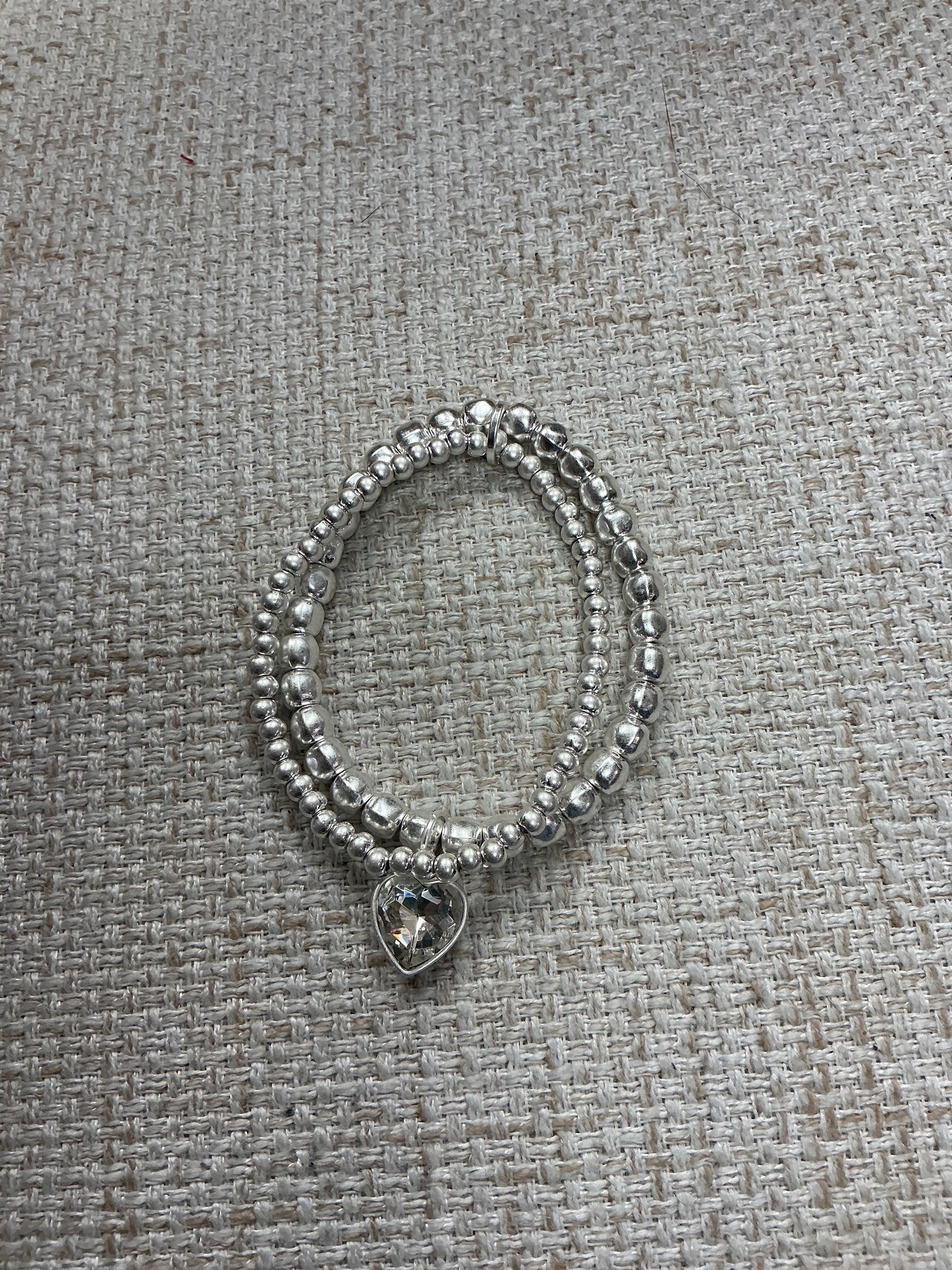 Double My Love bracelet by American Unique Group showing silver-toned metal with intertwined heart charms.