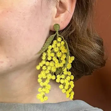 Embroidered mimosa flower brooch pin by Botanopia USA, featuring detailed yellow mimosa blossoms and green leaves.