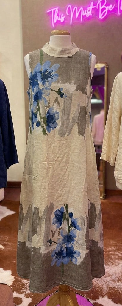 Flowered linen dress by Camille & Co., featuring a vibrant floral pattern, sleeveless design, and lightweight, breathable fabric.