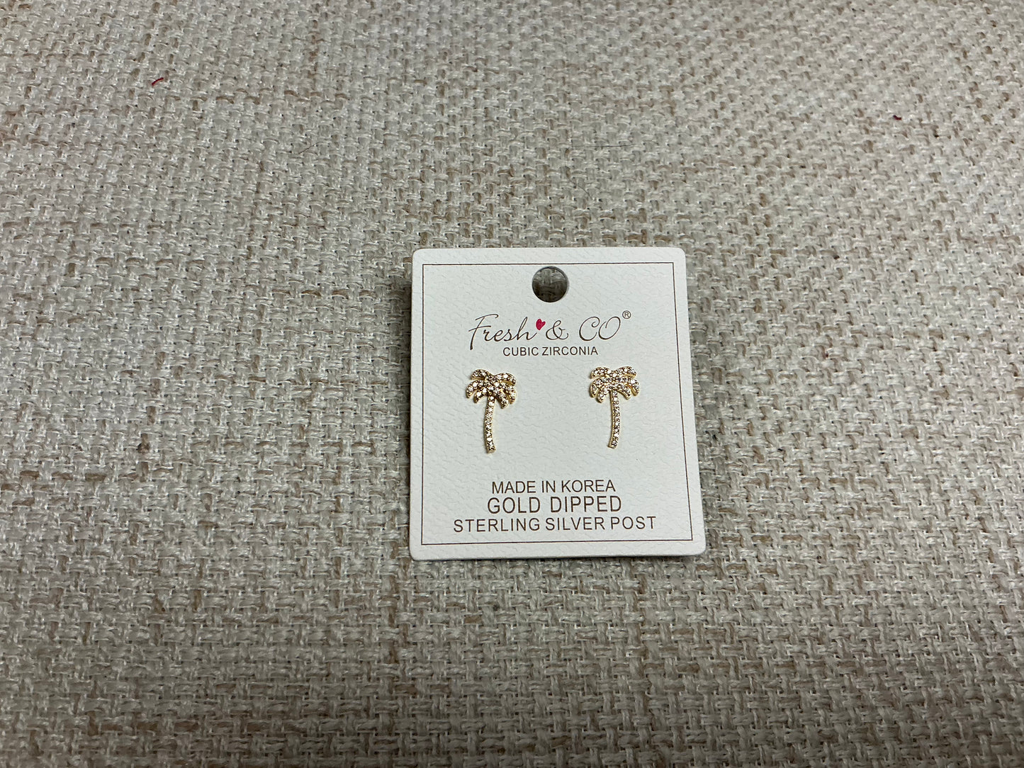 Small silver Tiny Palms earrings by SM Style featuring detailed palm tree designs on lightweight earrings.