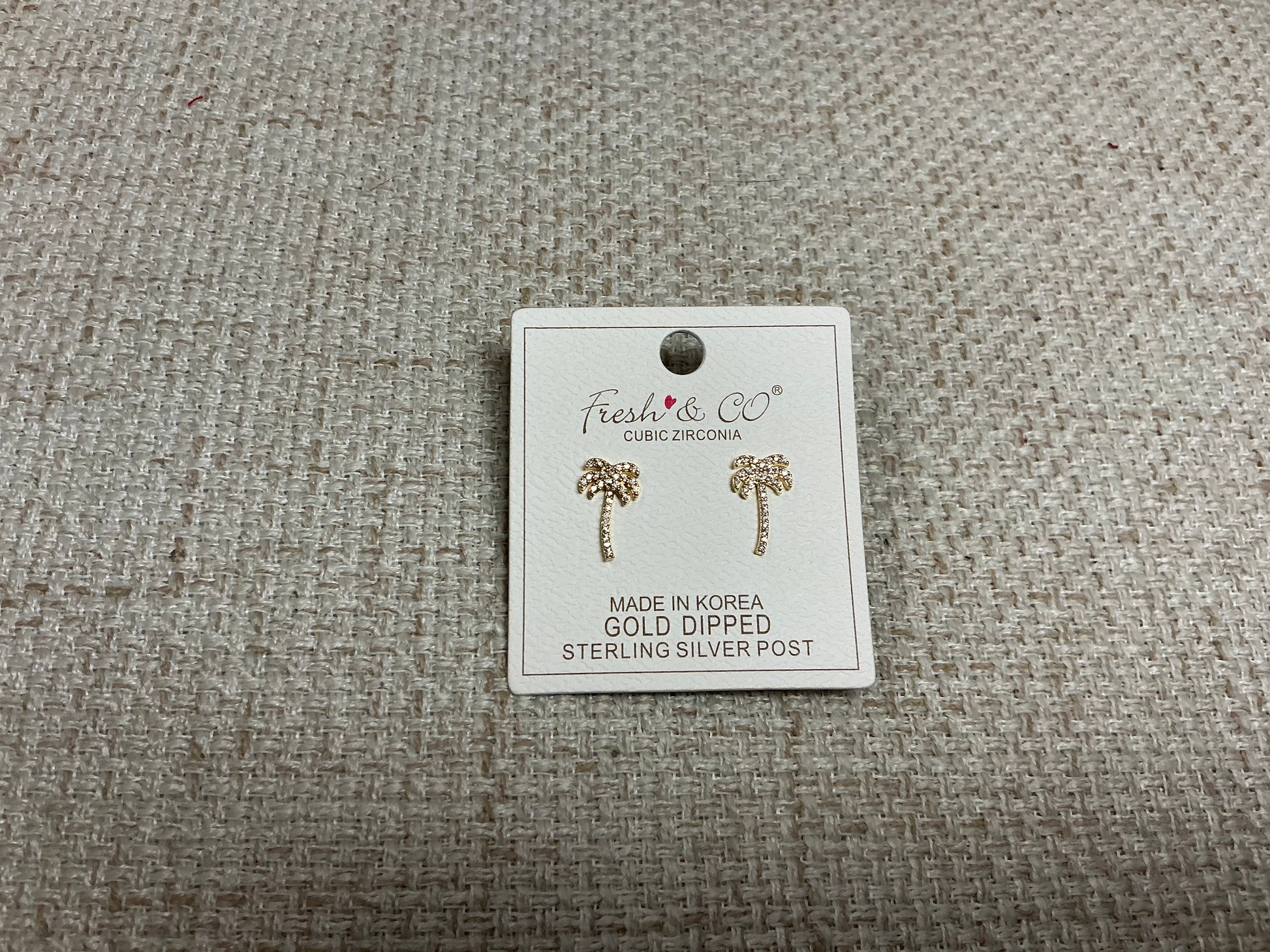 Small silver Tiny Palms earrings by SM Style featuring detailed palm tree designs on lightweight earrings.