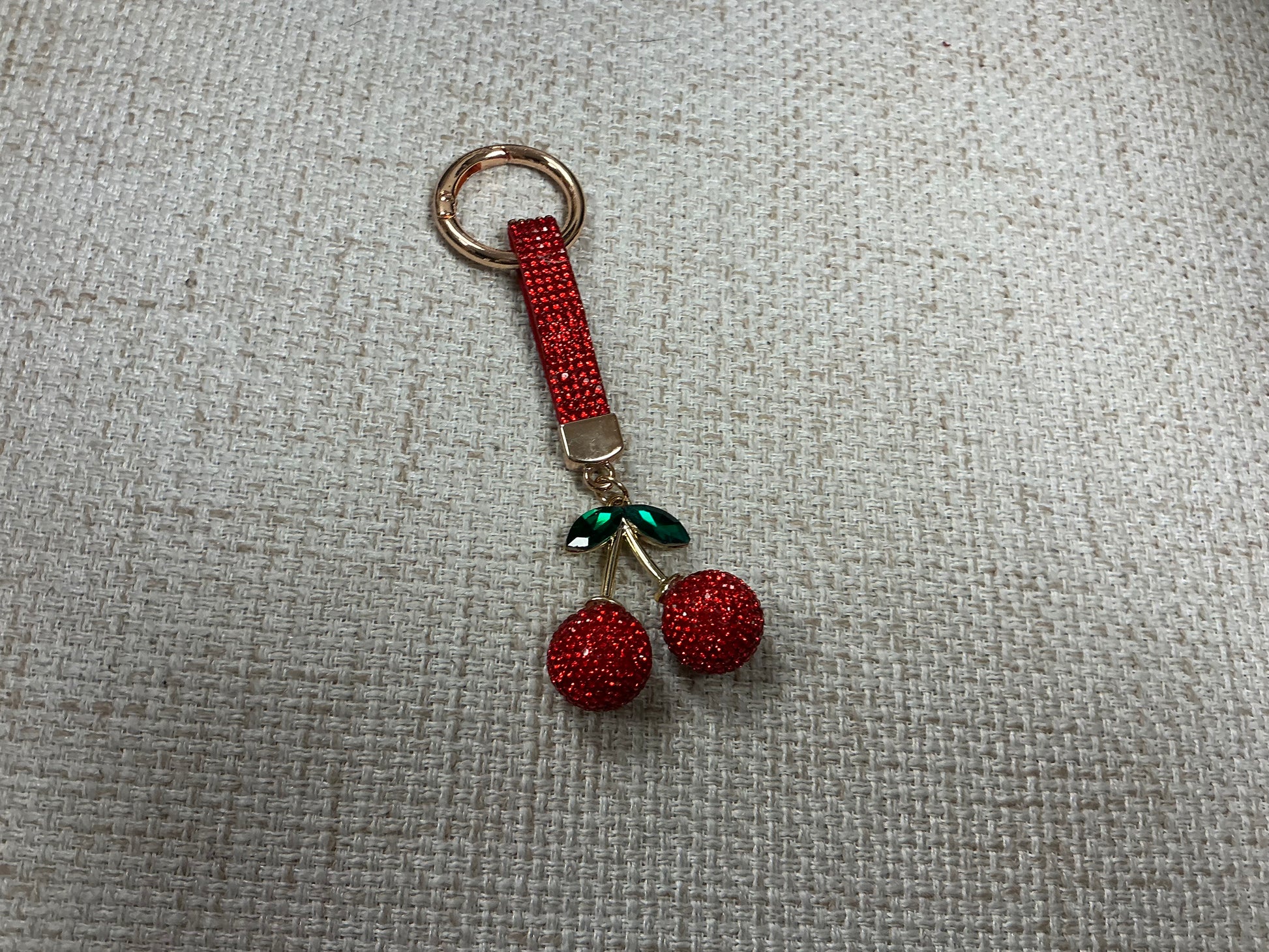 Glitter cherry keychain by Sunrise USA Trading featuring a shiny red cherry with glitter accents, attached to a metal keyring.