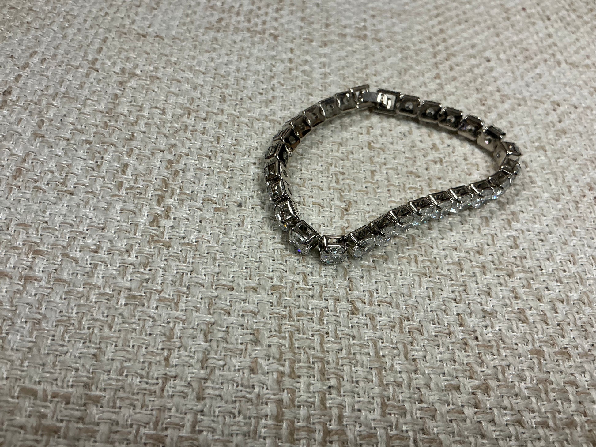 Silver "Tennis Anyone?" bracelet by Soiree Line featuring delicate tennis-themed charm and chain design.