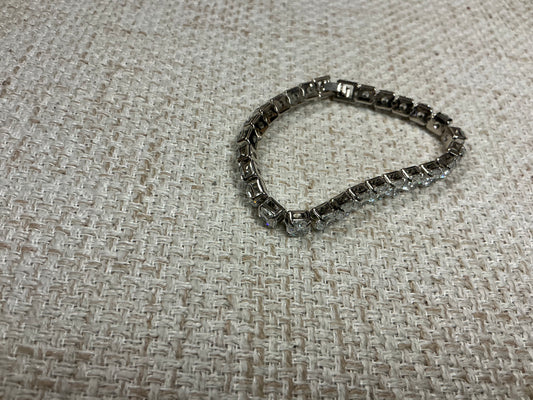 Silver "Tennis Anyone?" bracelet by Soiree Line featuring delicate tennis-themed charm and chain design.