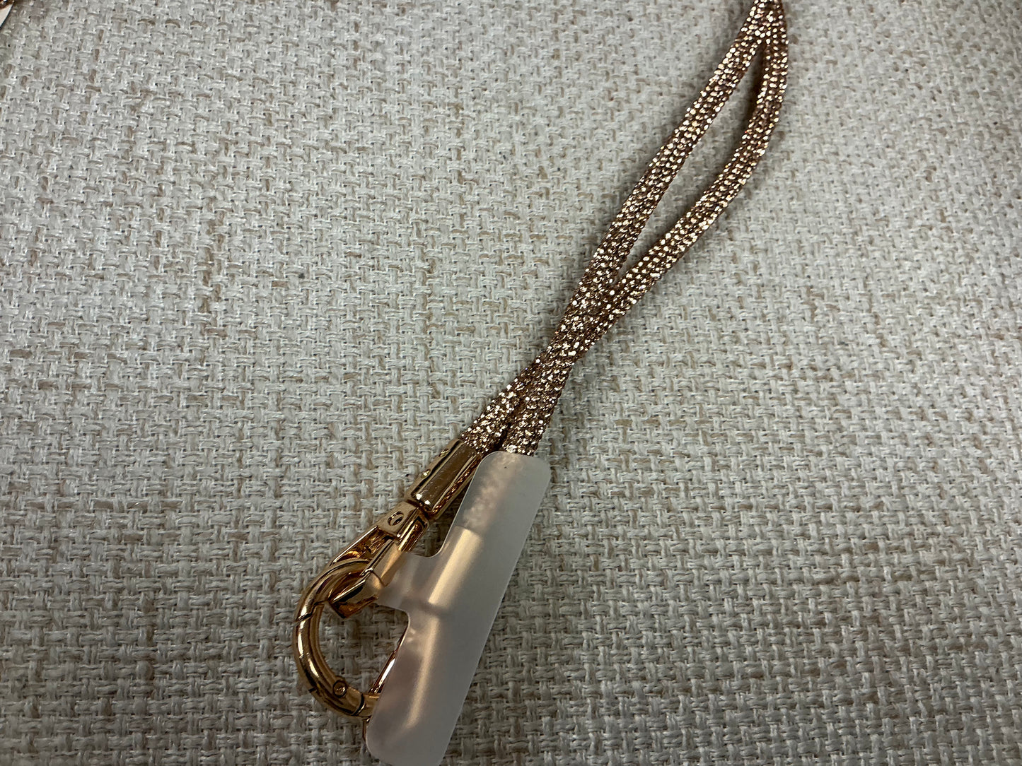 Sparkly glittery phone chain from Sunrise USA Trading featuring a stylish and vibrant strap for easy carrying.