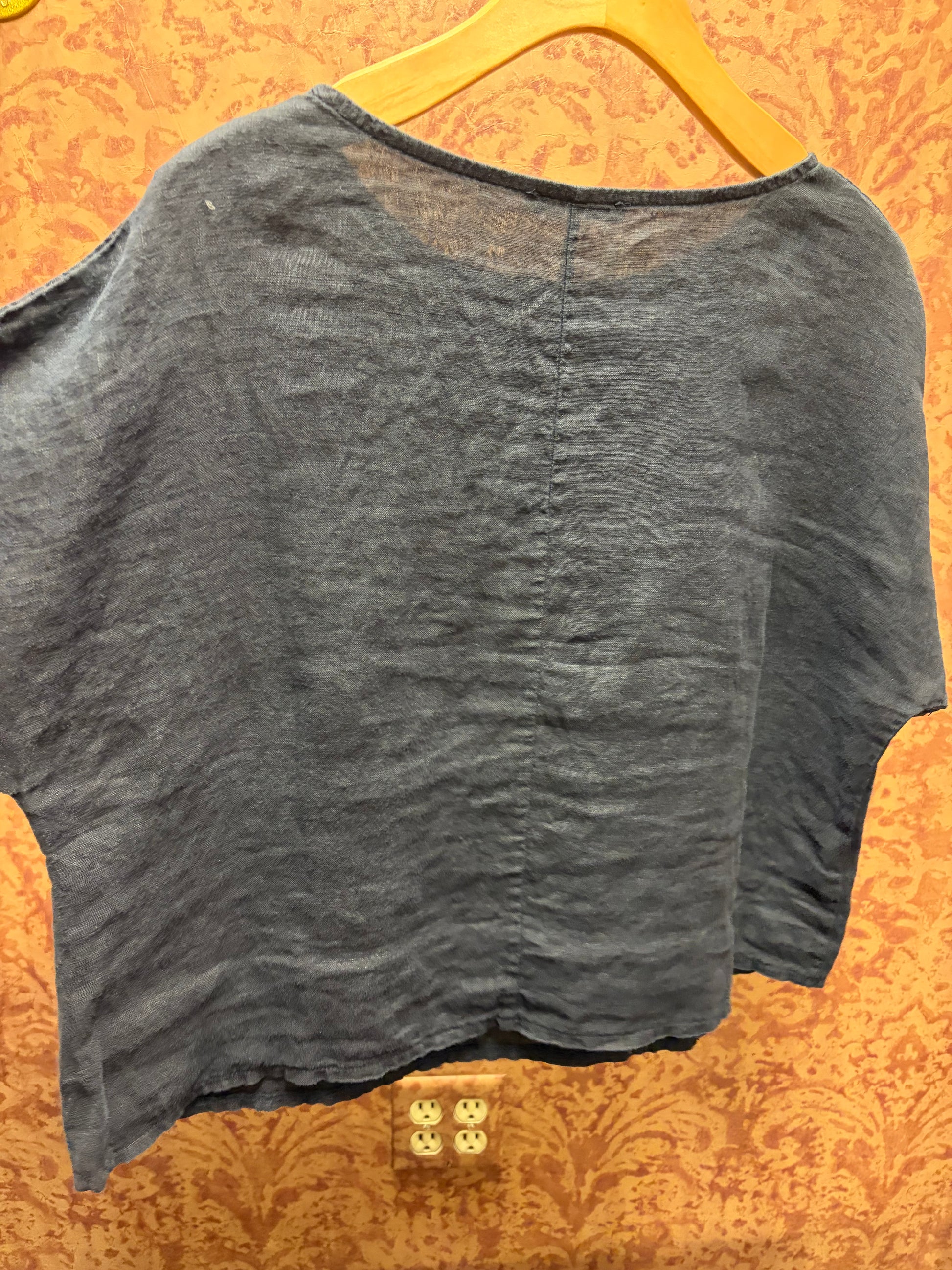 Light beige linen tee from Camille & Co. featuring a relaxed fit, short sleeves, and a classic crew neckline.