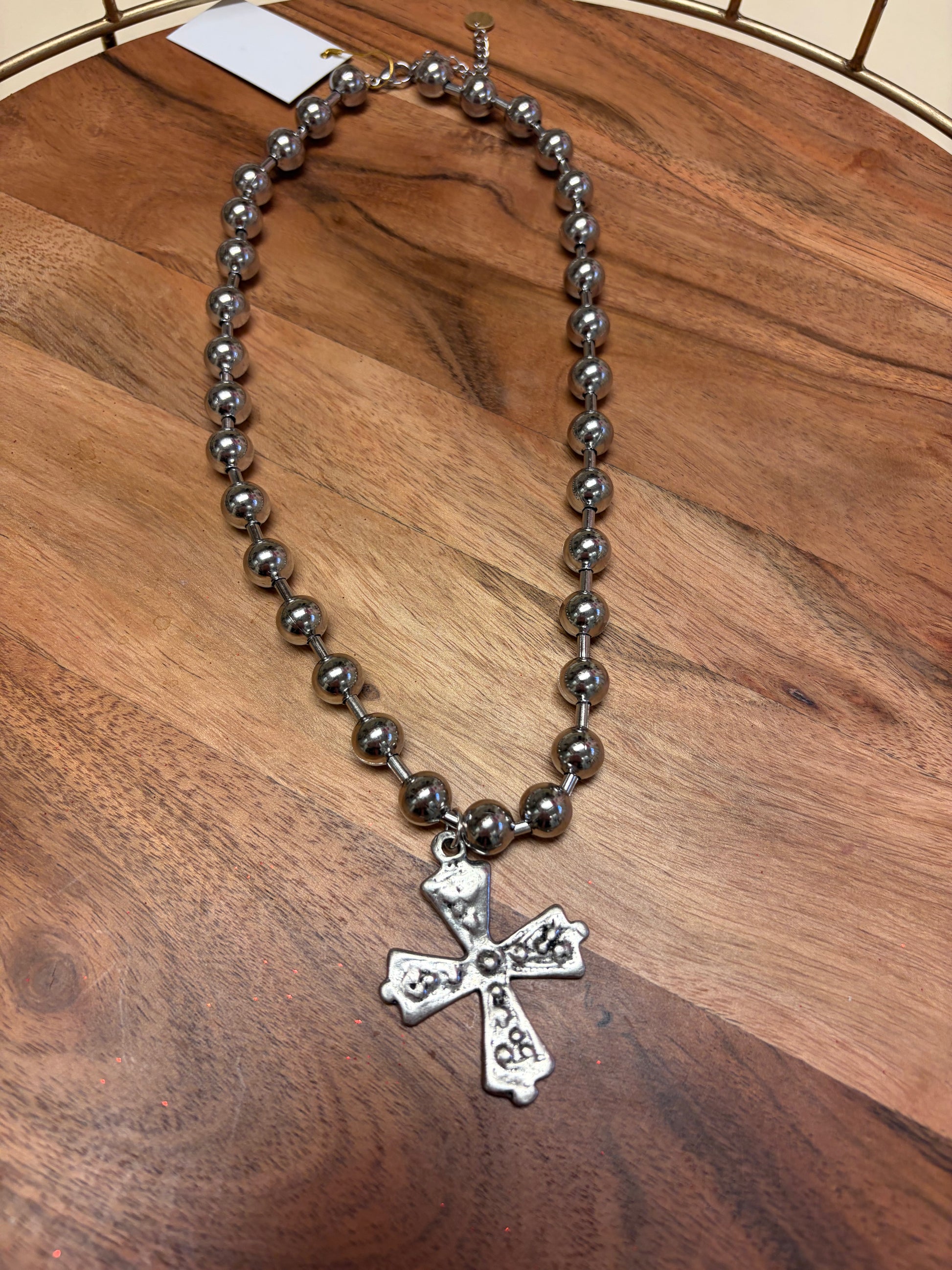 Lula 'n' Lee ball chain cross necklace showing a silver cross pendant on a ball chain necklace.