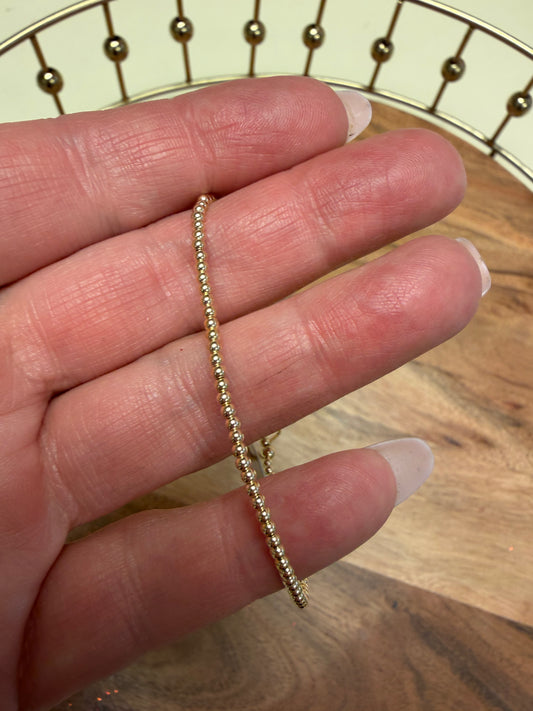 Gold filled beaded bracelet by Lula 'n' Lee featuring shiny beads and a delicate design on a neutral background.