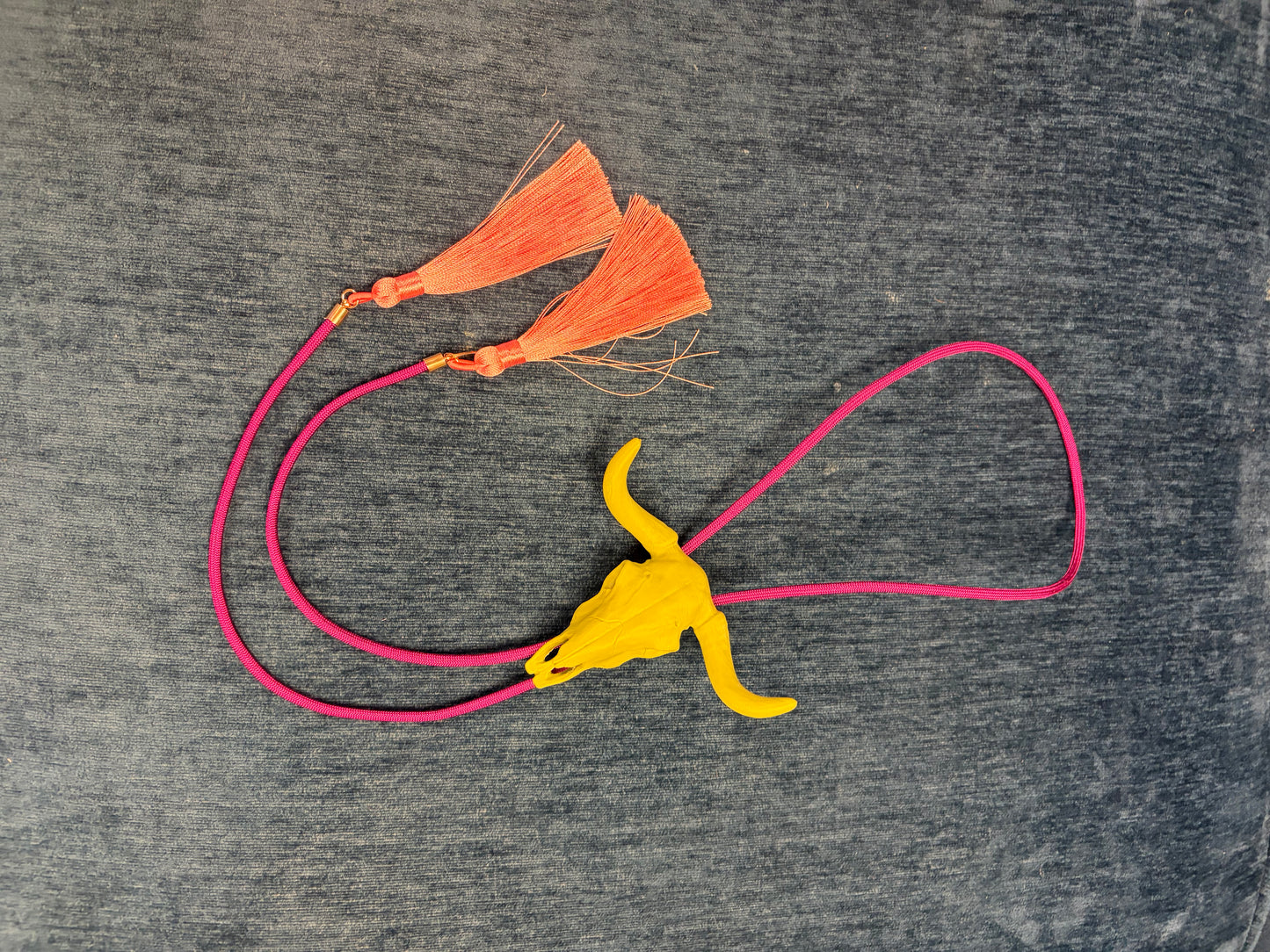 Rahya Bolo Necklace from Rahya Jewelry Design featuring a stylish bolo tie with decorative metal tips and intricate design details.